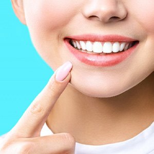 Close up of woman smiling and tapping her chin